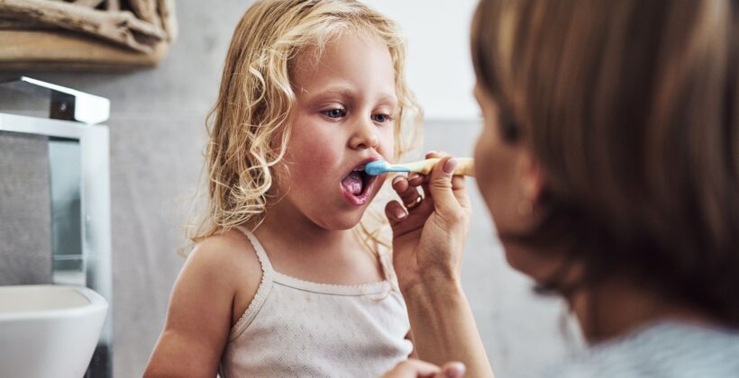 Child brushing teeth with parent - oral hygiene for kids, Midland Dental.